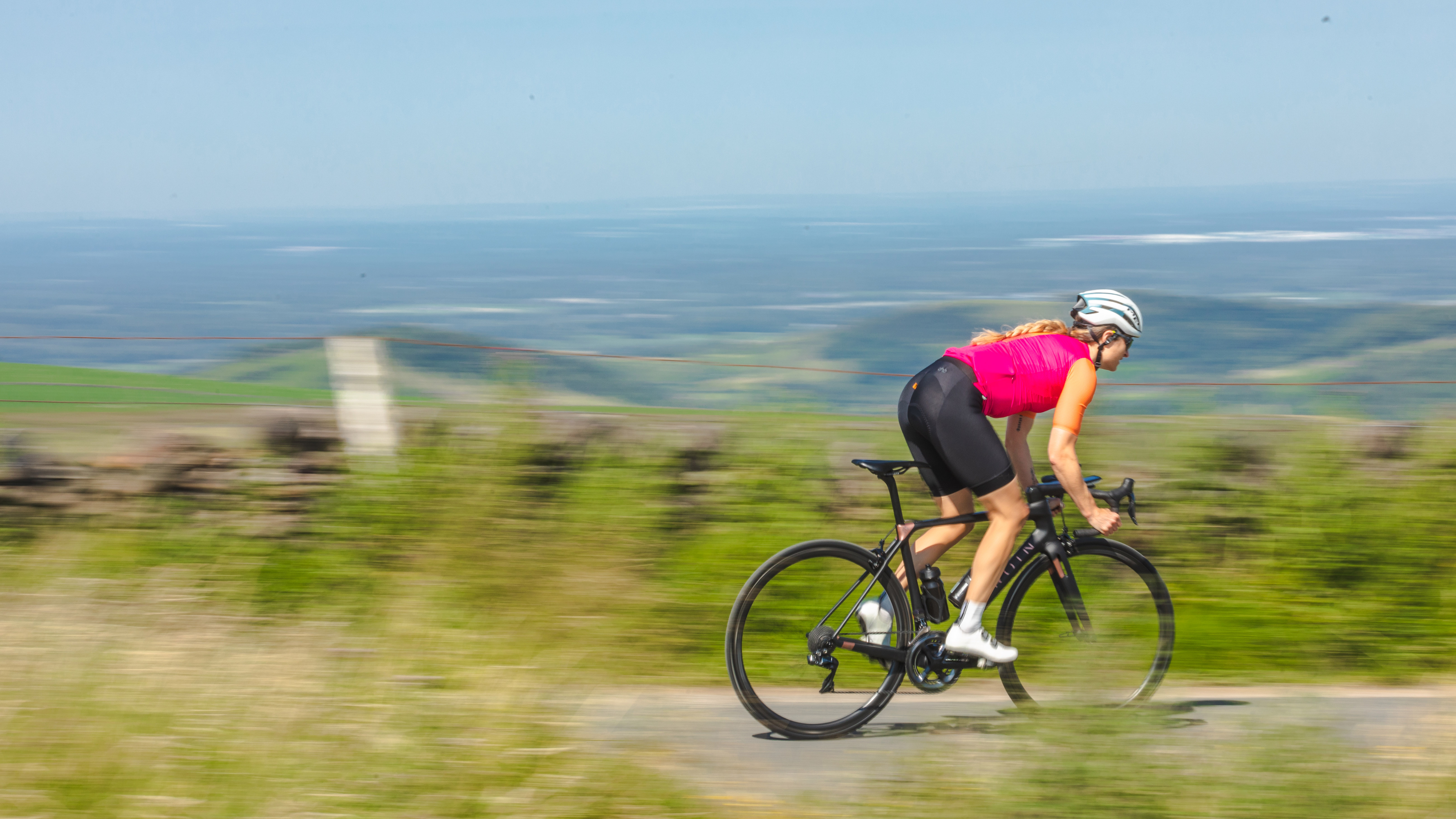 Female cyclist descending at speed