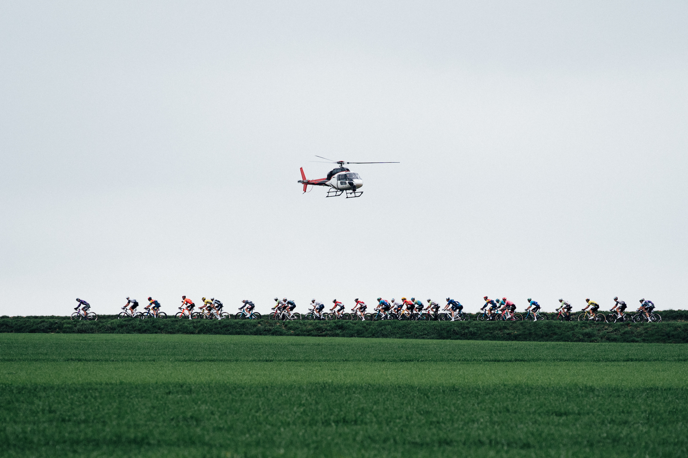 The peloton passes a helicopter at the E3 Saxo Classic